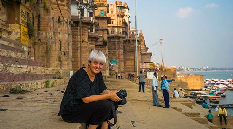 Mihaela Noroc silting on one of the Ghats or banks of the river Ganges in Varanasi India